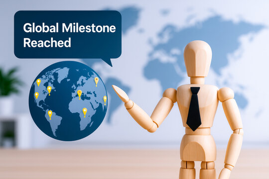 Wooden mannequin with tie celebrating success and recognition in front of world map with milestone markers, symbolizing global achievement