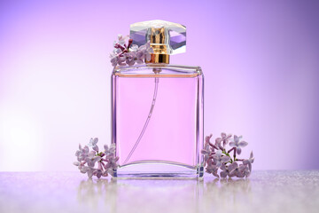 Beautiful lilac flowers and perfume on mirror surface against violet gradient background