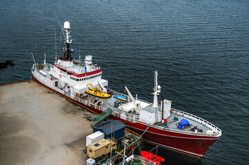 Top view fishing boat parking in harbor port