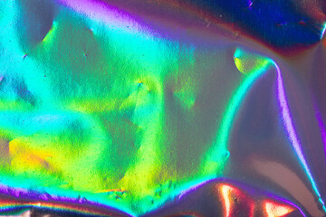 Rainbow neon background with holographic effect, crumpled plastic film