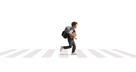 Schoolboy running on a street at a zebra crossing