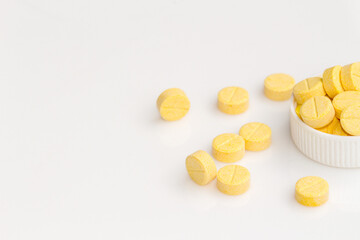 yellow medical pills on white background