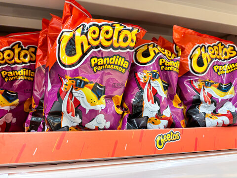 Alicante, Spain - May 20, 2025: Cheetos Pandilla Fantasmas snack bags displayed on a supermarket shelf, showcasing vibrant packaging and playful character design for enticing snack options