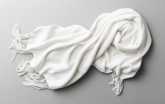 Soft, white shawl draped on gray surface