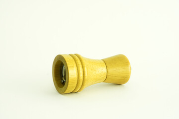 Wooden grinder for salt or pepper isolated on white background.
