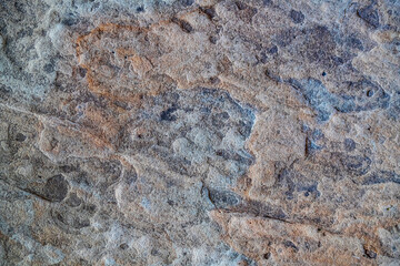 Close-up of weathered rock surface with layers.Textured mineral surface for nature-related visuals.
