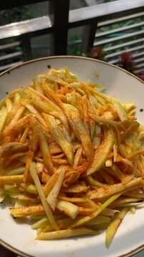 peeled mangoes in a bowl. Fresh sweet and sour fruits. Fresh raw green mango ready to be pickled or smashed. fresh young mango and leaf, tropical fruit. mango slice.