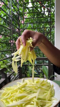 peeled mangoes in a bowl. Fresh sweet and sour fruits. Fresh raw green mango ready to be pickled or smashed. fresh young mango and leaf, tropical fruit. mango slice.