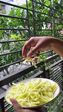 peeled mangoes in a bowl. Fresh sweet and sour fruits. Fresh raw green mango ready to be pickled or smashed. fresh young mango and leaf, tropical fruit. mango slice.