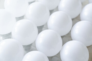 round white LED light bulb. many modern light bulbs on a white