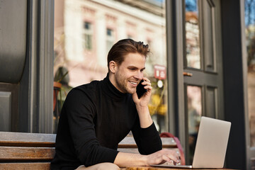 Handsome man enjoying a walk while engaged in a phone conversation