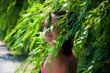 Leaf movement. Woman in green windy willow. Summer countryside. Outdoor lifestyle in nature. Willow...