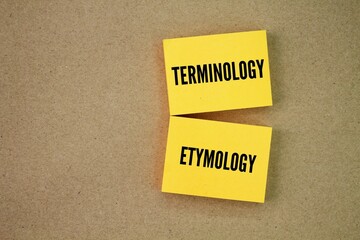 Yellow paper with the words terminology and etymology. system of terms used collectively in a...