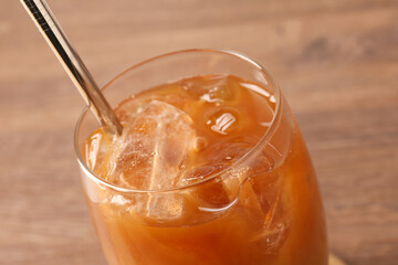 Tasty iced coffee on wooden table, closeup