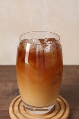 Tasty iced coffee on wooden table, closeup
