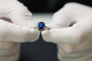 Appraiser working with luxury ring at table, closeup