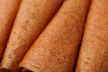 Delicious fruit leather rolls as background, closeup