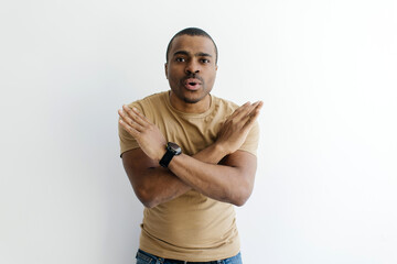 Portrait Of Young Black Guy Showing Stop Gesture With Crossed Hands, Serious Millennial African...