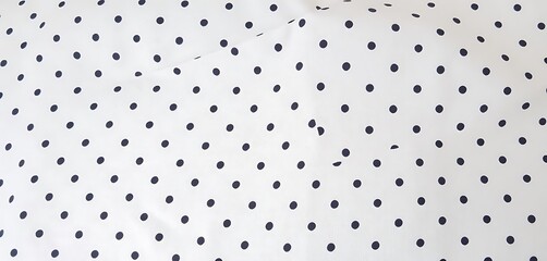 Minimal polka dot cotton fabric texture with soft feel, perfect for apparel, decor, or crafts.

