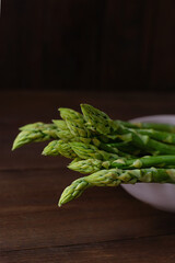 Close up of asparagus on wooden background