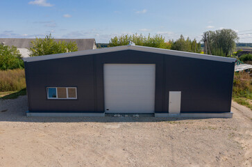 Modern Warehouse Building With a Large Garage Door on a Sunny Day