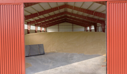 Interior of Grain Storage Facility Featuring Red Walls and Stockpiled Harvested Grains