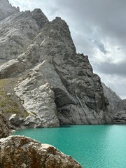 Kyrgyzstan, Bishkek, Ala Archa - 03.08.2024 - Ascent to Komsomolets Peak in the national park. A girl climber goes on the route to the top, around her stunning views