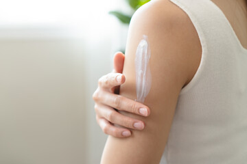 Health skin care, beauty smile asian young woman, girl  hand applying, putting moisturizer on her...