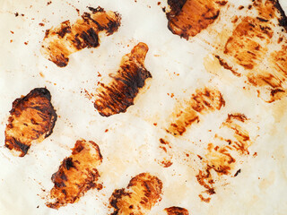 Cooking paper with prints of small sausages and grease after cooking.
