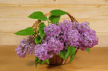 Lilac bouquet in a wicker basket