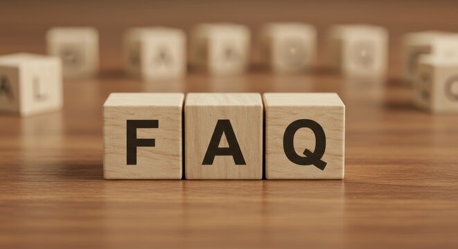 Wooden blocks spelling faq on a wood surface with blurred background.