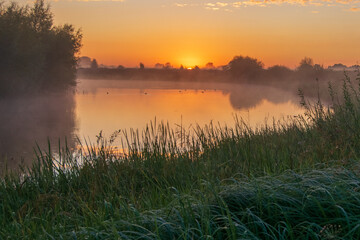 sunrise on the river and grassland