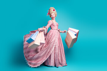 Full size photo of young aristocratic woman shopping bags wear baroque dress isolated on teal color...