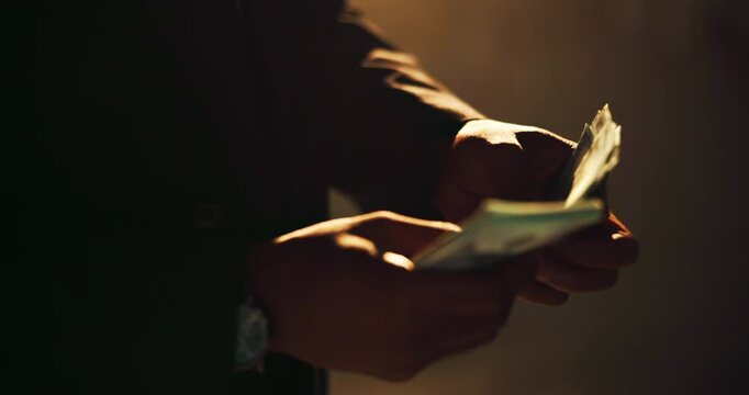 Hands, fraud and counting cash for profit, money laundering and investment scam in crime syndicate. Night, bank notes and person with wealth from criminal activities, corruption and illegal business