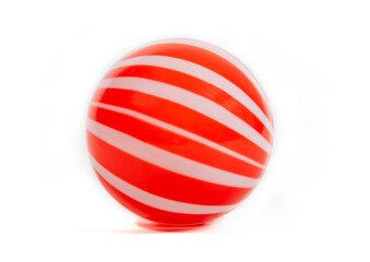Red and white striped plastic ball, children's toy, isolated on white background