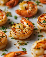 Close-up of roasted shrimps with herbs on baking paper.