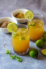 Fototapeta premium Jal Jeera is a tangy, spicy Indian beverage made with cumin, mint, lemon, and black salt, known for its refreshing and digestive properties.