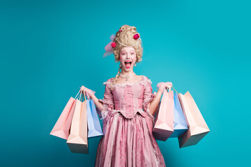 Photo of young aristocratic woman hold shop bags wear baroque dress isolated on teal color...