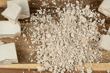 Compressed fresh yeast cubes close-up on a wooden background