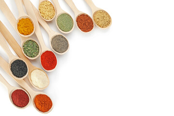 Different aromatic spices in spoons isolated on white, top view