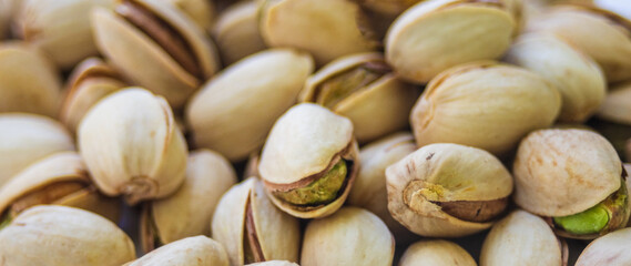 Close-up of pistachios in natural light .Natural antioxidant food concept.Macro photography of pistachios with special attention to texture and freshness. Ideal for vegan and healthy eating images.