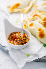 Traditional empanadas with chimichurri sauce. Latin American cuisine.