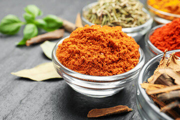 Different aromatic spices on grey table, closeup