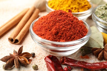 Different aromatic spices on color textured table, closeup