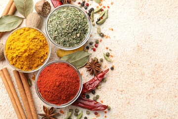 Different aromatic spices on color textured table, flat lay. Space for text