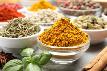 Different aromatic spices on grey table, closeup