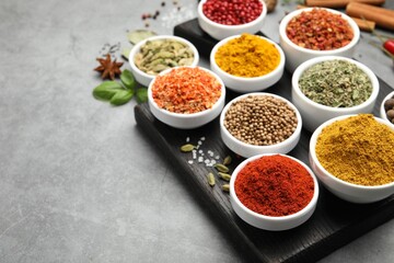 Different aromatic spices on grey table, closeup. Space for text