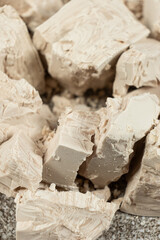 Compressed fresh yeast cubes close-up