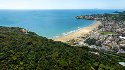 Naklejka premium Aerial view of Serapo bay overlooking the Mediterranean Sea. It is the main beach of Gaeta, in the province of Latina, Lazio, Italy. In background there is Ponza island.