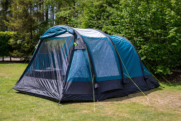 An air tent set up for camping in a forest campsite